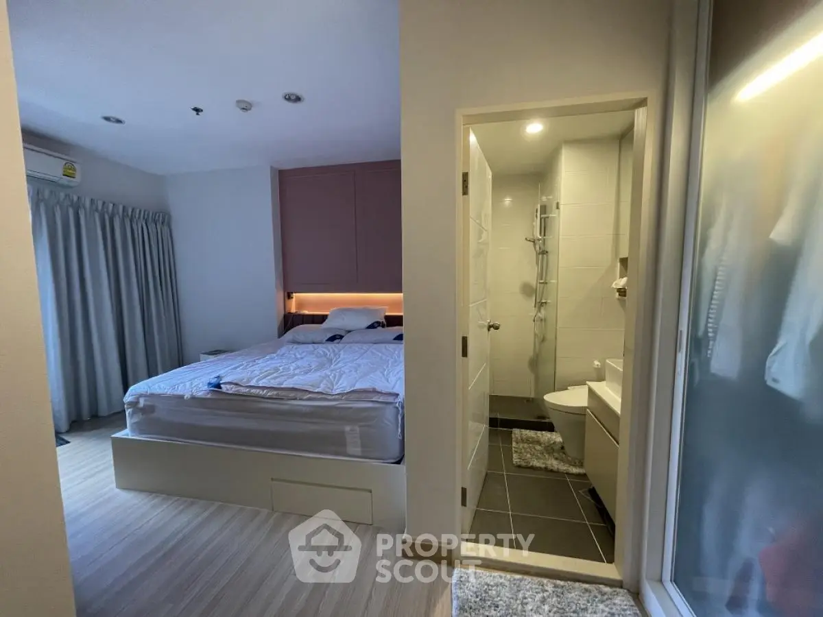 Modern bedroom with ensuite bathroom, featuring cozy lighting and sleek design.