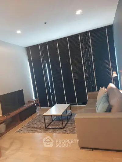 Modern living room with sleek furniture and large windows, perfect for urban living.