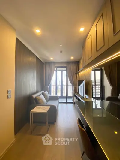 Modern living room with sleek design and balcony view, featuring stylish furniture and ambient lighting.