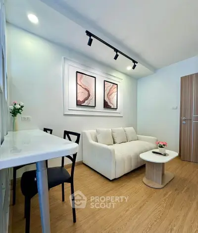 Modern living room with stylish decor and cozy seating in a contemporary apartment.
