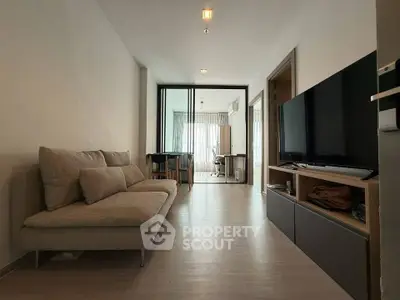 Modern living room with sleek furniture and natural light in a stylish apartment.