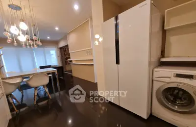 Modern kitchen with sleek appliances and stylish lighting, perfect for contemporary living.