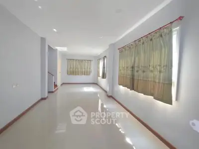 Spacious unfurnished living room with large windows and natural light