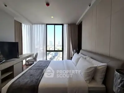 Luxurious bedroom with city view, modern furnishings, and ample natural light.