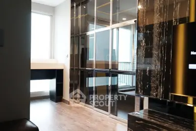 Luxurious modern living room with sleek black marble accents and floor-to-ceiling windows.