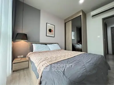 Modern bedroom with stylish decor and cozy ambiance, featuring a comfortable bed and sleek furniture.