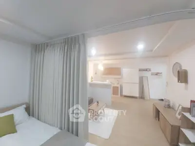 Modern open-plan living room with cozy bedroom and stylish kitchen