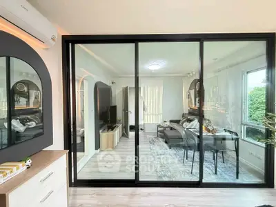 Modern living room with glass partition and stylish decor