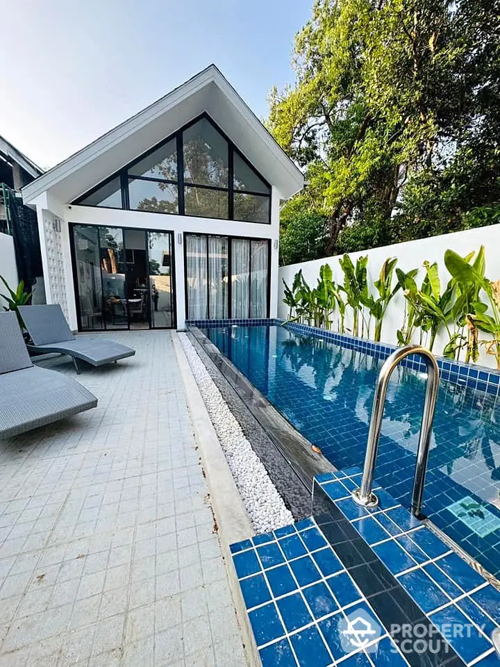 Modern villa with private pool and lush garden, perfect for luxury living.