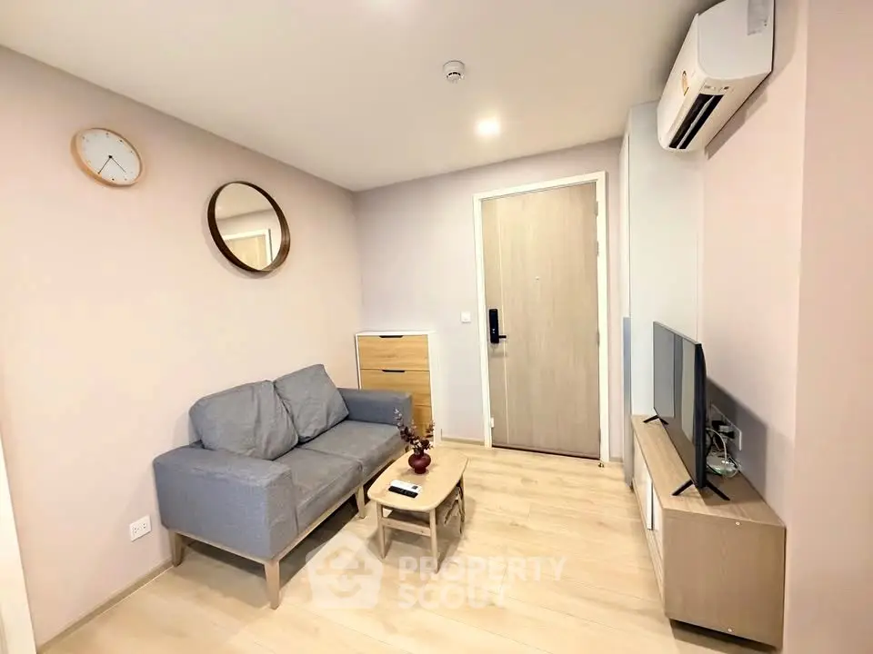 Cozy living room with modern decor and air conditioning, perfect for relaxation.