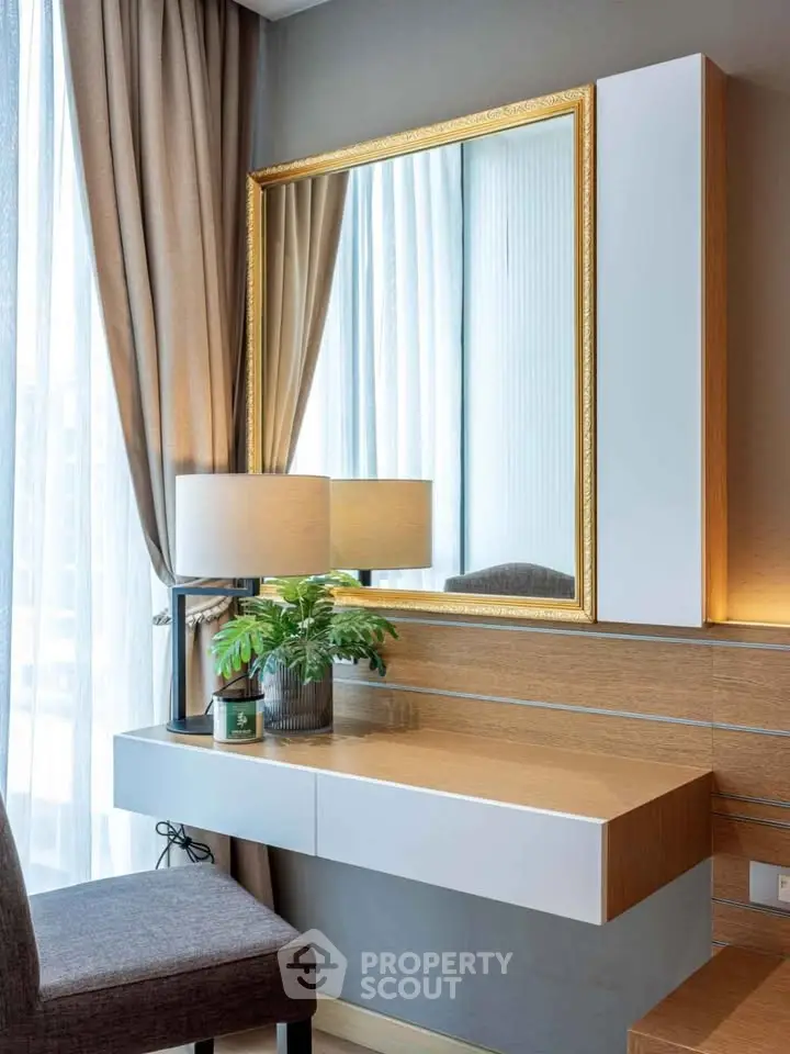 Elegant modern study nook with stylish desk, mirror, and lamp in a bright room with floor-to-ceiling curtains.