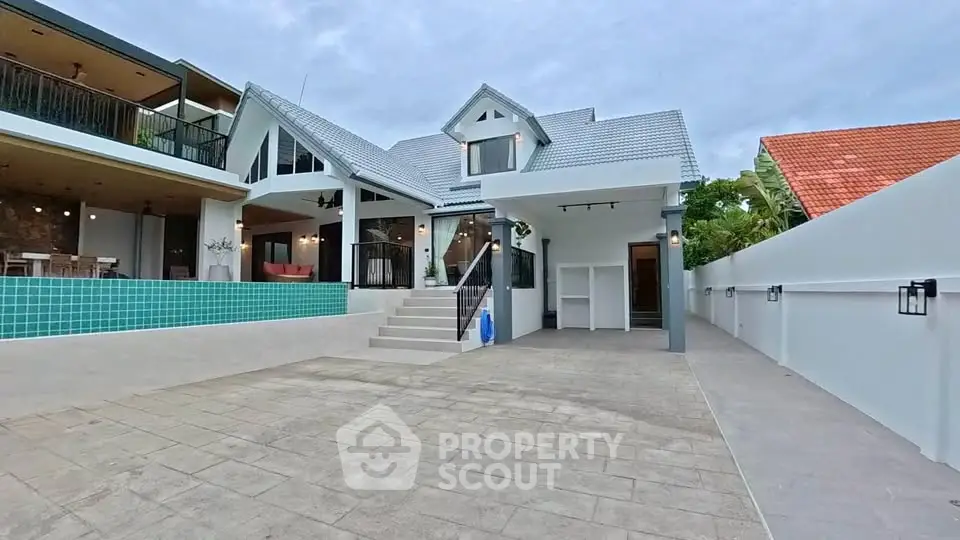 Stunning modern villa with pool and spacious driveway, perfect for luxury living.