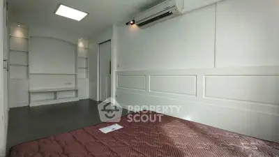 Spacious bedroom with modern design and built-in air conditioning unit.
