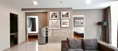 Spacious modern living room with stylish decor and comfortable seating in a contemporary apartment.