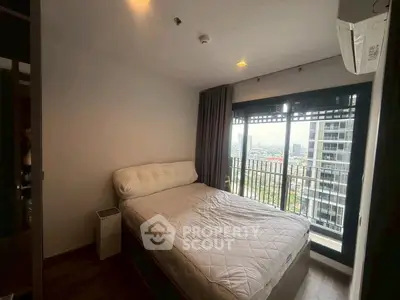 Cozy bedroom with city view and modern furnishings in high-rise apartment