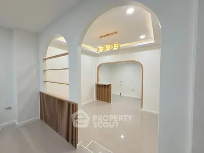 Modern minimalist interior with archways and sleek lighting