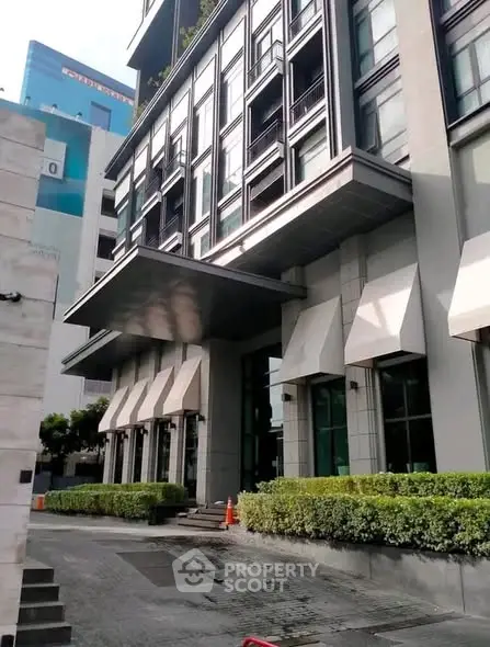 Modern building exterior with sleek design and lush greenery