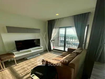 Cozy living room with balcony view and modern furnishings