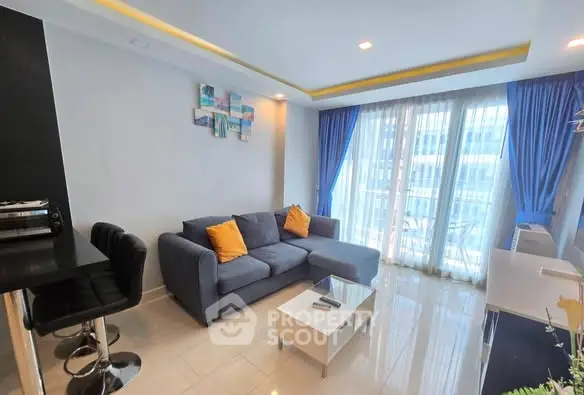 Modern living room with stylish decor and large windows offering natural light.