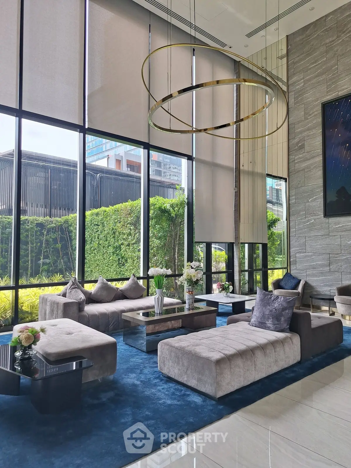 Luxurious modern living room with plush seating and large windows offering garden views.