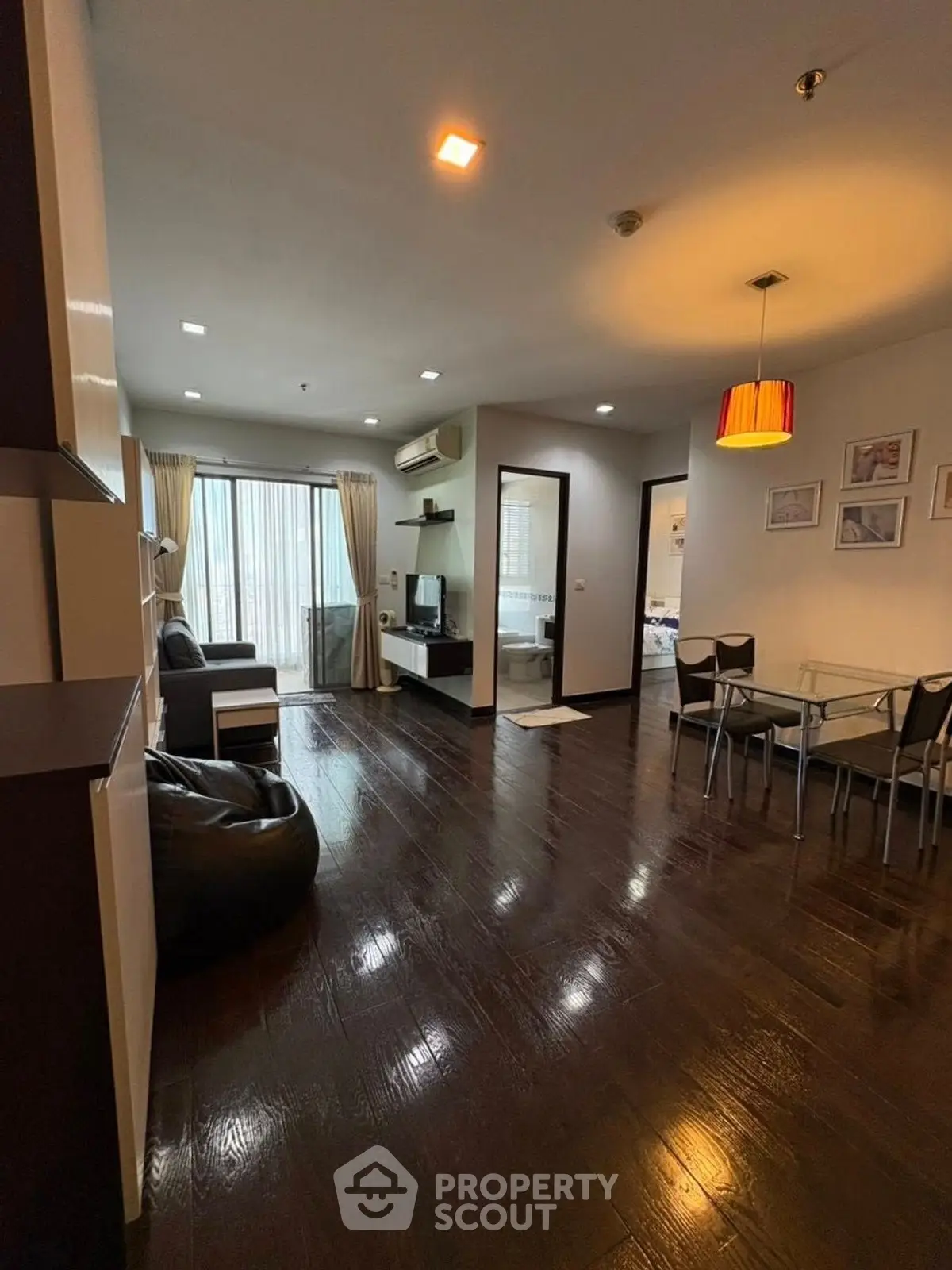 Spacious modern living room with dark wood flooring and stylish decor