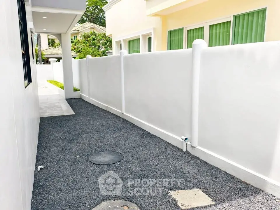 Charming exterior walkway with privacy wall and modern design in a serene neighborhood.