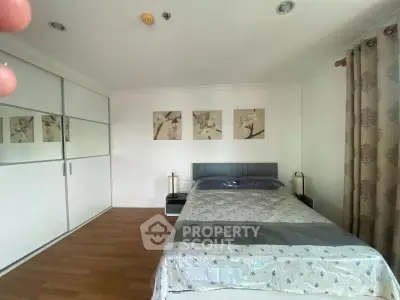 Spacious bedroom with modern decor and ample closet space