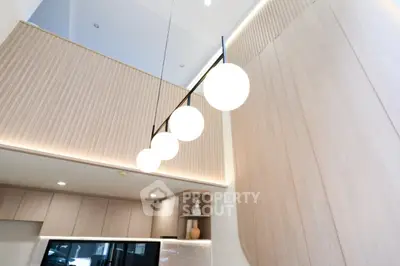 Modern kitchen with stylish lighting and wooden cabinetry