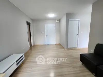 Spacious modern living room with sleek wooden flooring and minimalist design