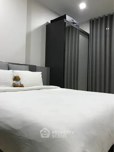 Cozy modern bedroom with plush bedding and sleek wardrobe