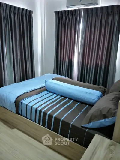 Cozy bedroom with stylish bedding and natural light through elegant curtains