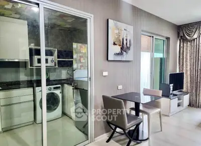Modern apartment interior with glass-enclosed kitchen and cozy dining area, featuring sleek appliances and stylish decor.