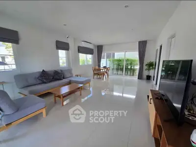 Spacious modern living room with natural light and stylish furniture