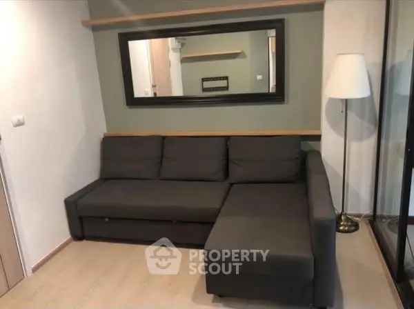 Cozy living room with modern gray sectional sofa and stylish floor lamp