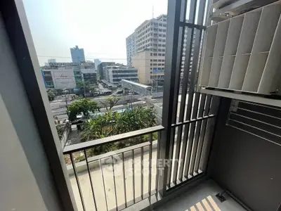 Urban balcony with city view, perfect for enjoying the vibrant cityscape and outdoor relaxation.