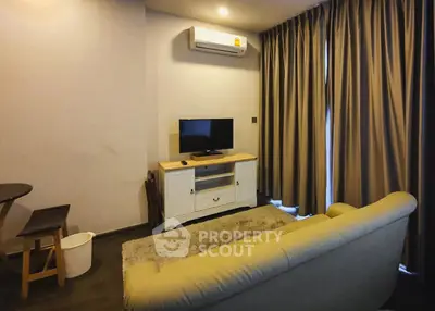 Cozy living room with modern air conditioning and elegant curtains, perfect for relaxation.