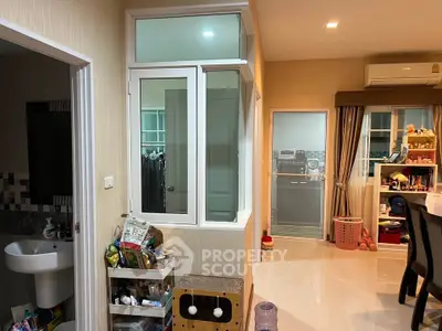 Spacious interior with modern decor and ample natural light, featuring a cozy living area and organized storage solutions.