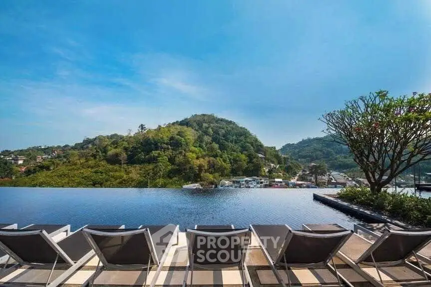 Luxurious infinity pool with stunning mountain views and sun loungers in a serene setting.