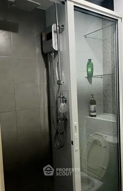 Modern bathroom with glass shower enclosure and sleek fixtures