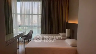 Modern bedroom with twin beds and city view from large window.