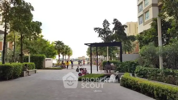 Luxurious garden view in modern residential complex with lush greenery and elegant pathways.