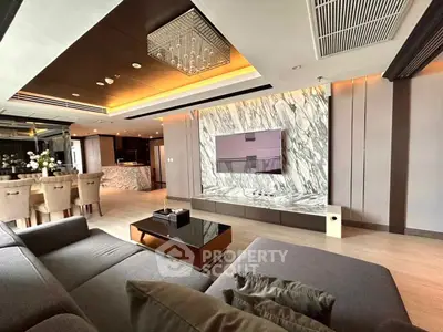 Luxurious modern living room with marble accents and open kitchen layout