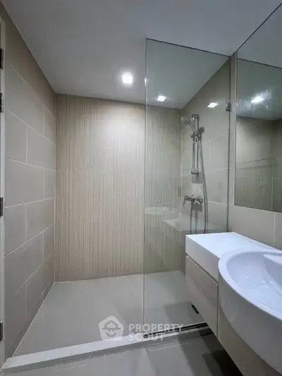 Modern bathroom with glass shower and sleek sink design