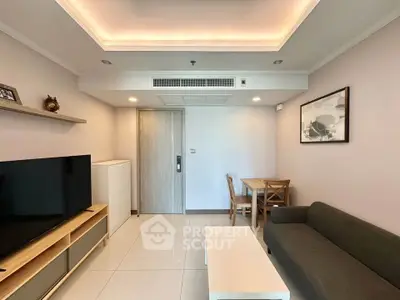 Modern living room with sleek furniture and ambient lighting, perfect for relaxation and entertainment.