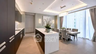 Luxurious open kitchen and dining area with elegant decor and natural light