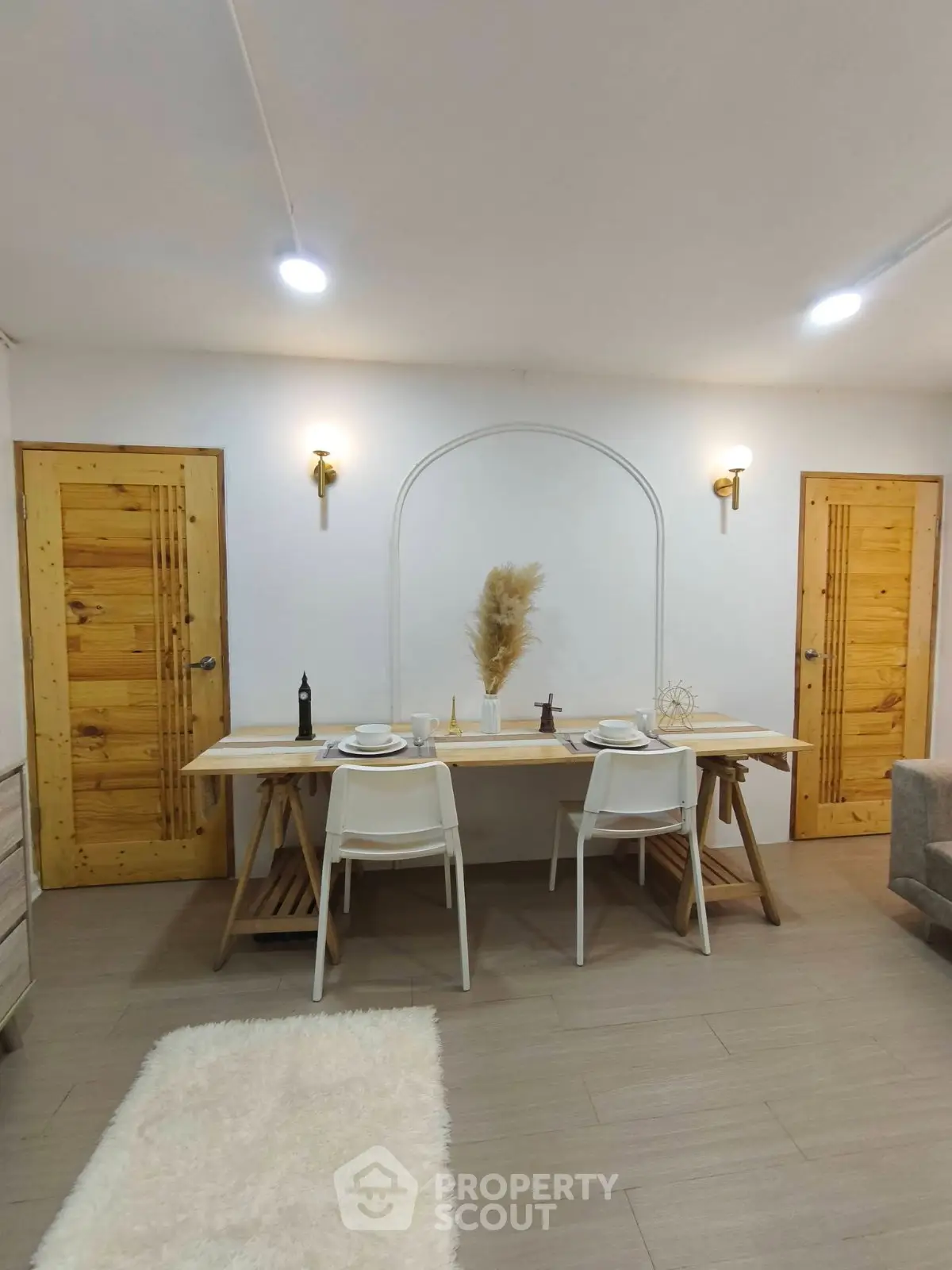 Charming dining area with rustic wooden doors and modern decor, perfect for cozy meals.
