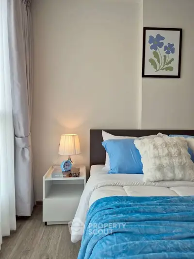Cozy bedroom with stylish decor and soft blue accents, perfect for relaxation and comfort.