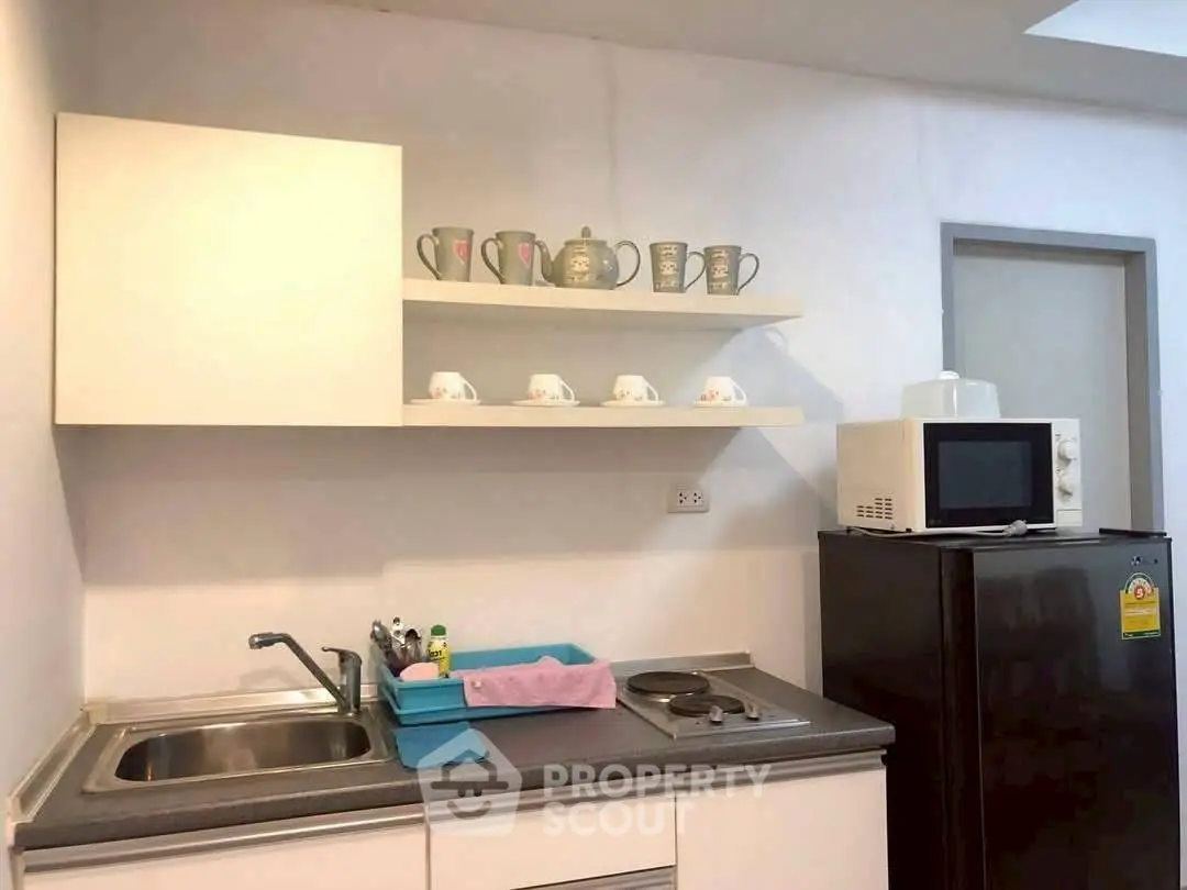 Modern kitchen with sleek appliances and open shelving