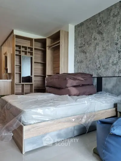 Modern bedroom with stylish wooden closet and cozy bed in a contemporary apartment.