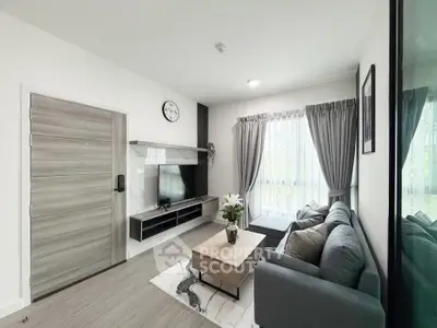 Modern living room with sleek furniture and natural light, perfect for relaxation and entertainment.